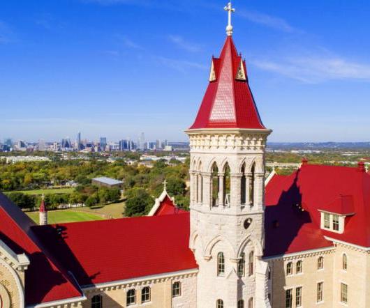 an aerial view of Main Building and the downtown Austin skyline.